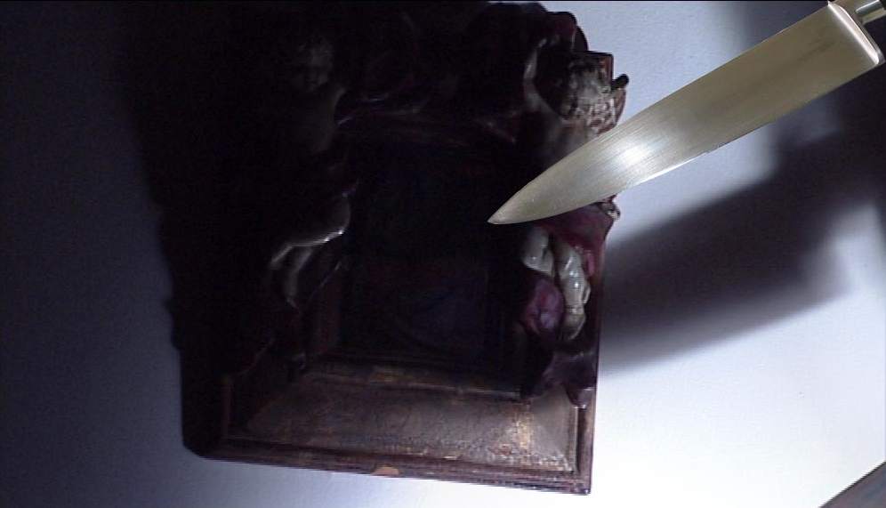 the shadow of a knife on a wall